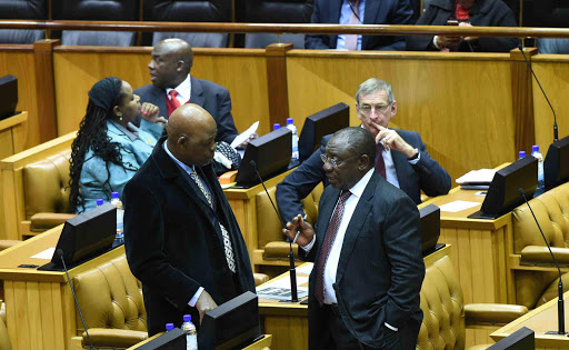 STEERING THE SHIP: Deputy President Cyril Ramaphosa in the National Assembly chamber yesterday during the oral replies to questions by members of parliament in Cape Town. Here he speaks to the ANC’ s chief whip Stone Sizani Picture: GCIS