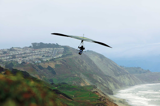 Hang gliding over the cliffs at scenic Fort Funston on the western edge of San Francisco. 