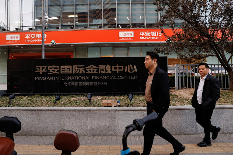 People walk past the Ping An International Financial Center in Beijing, China, on November 8 2023. Picture: REUTERS/TINGSHU WENG