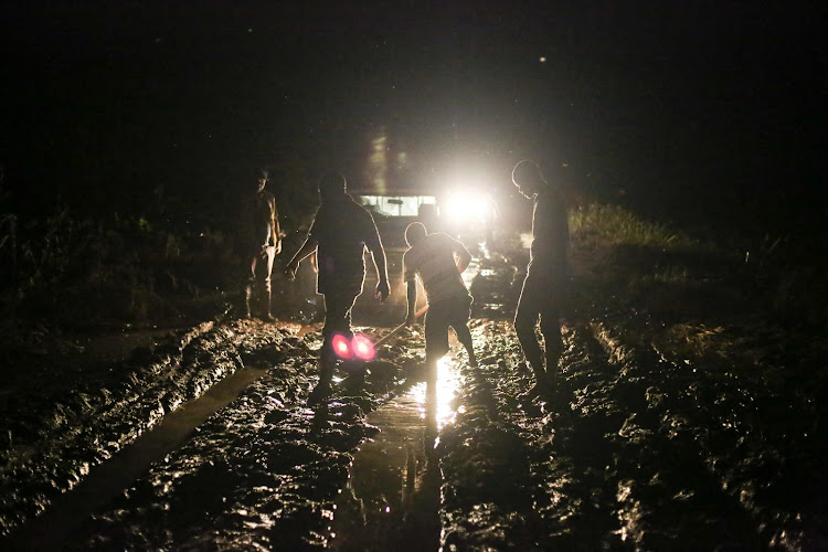 Residents work to free a truck carrying the sick and injured from Begaja to a nearby clinic.