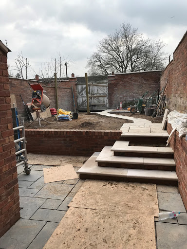 3/4 through a rear garden landscape, including new patio, bullnose stone steps, retaining garden walls and fencing