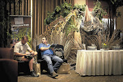 Two men compare notes as they participate in the Ezemvelo KZN Wildlife game auction at the Sibaya Casino near Durban