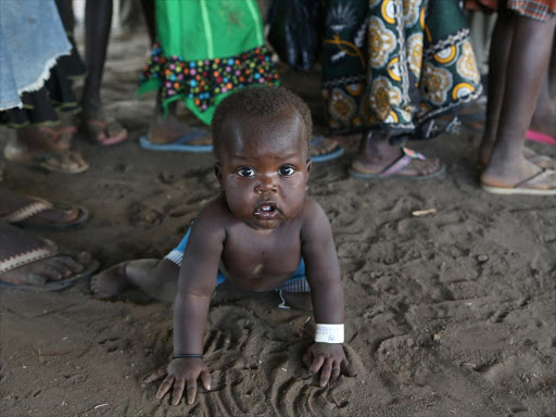 A refugee child from South Sudan plays on arrival at Bidi Bidi refugee’s resettlement camp near the border with South Sudan, in Yumbe district, northern Uganda December 7, 2016. /REUTERS