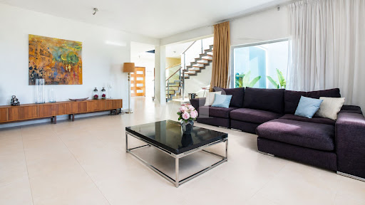 Modern living room with purple sectional sofa in this luxury property for sale in Loulé ($2,087,392 - 300 m²)