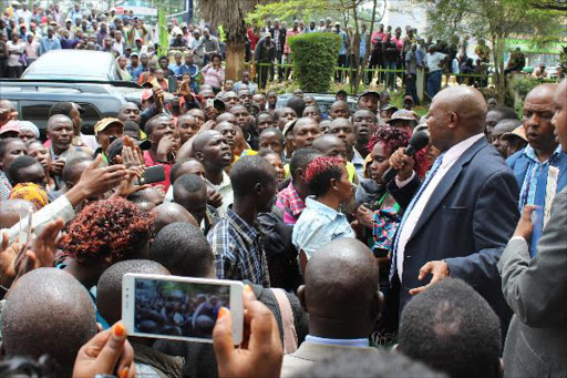 Supporters of murdered Kalenjin mucisian Diana Chemutai, alias Chelele, listen to an address by Kericho Governor Paul Chepkwony outside his office, February 8, 2016. Photo/SONU TANU