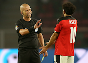 Referee Victor Gomes talks to Egypt captain Mohamed Salah during the 2021 Africa Cup of Nations final match against Senegal at Olembe Stadium in Yaounde, Cameroon, on February 6 2022.