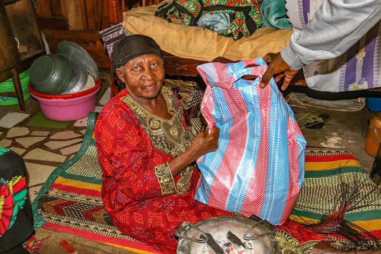 Zaituni Noah receives food from Nubian Youth Council