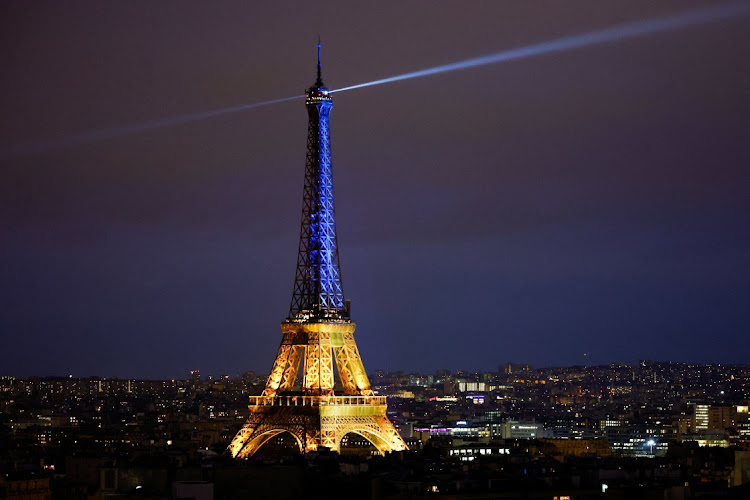 The Eiffel Tower is lit up in the national blue-and-yellow colours of Ukraine, to mark the first anniversary of Russia's invasion of Ukraine, in Paris, France, February 23, 2023.