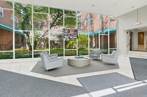 Modern living room with armchairs and coffee table in this luxury apartment / penthouse for sale in Scarsdale ($470,000)