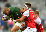 Zain Davids of the Blitzbok  evades a tackle from a player from Great Britain on day 2 of the HSBC Cape Town Sevens at DHL Stadium on December 10, 2022 in Cape Town, South Africa.