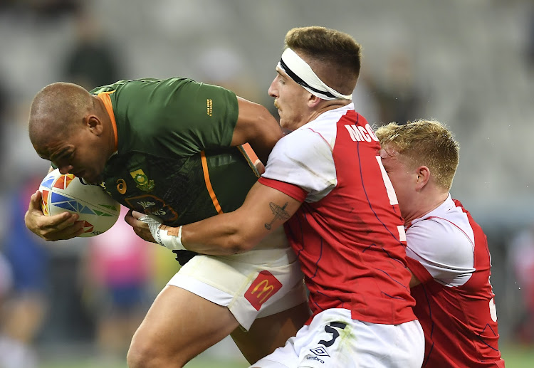 Zain Davids of the Blitzbok evades a tackle from a player from Great Britain on day 2 of the HSBC Cape Town Sevens at DHL Stadium on December 10, 2022 in Cape Town, South Africa.