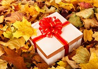 Gift box in fall foliage. Autumn holiday.