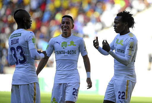 Percy Tau of Downs, right, celebrates a goal with Khama Billiat and Gaston Sirino.