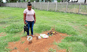 Jeanette Brown stands next to the grave of her  brother Elwon Scharnick  who was given a pauper's funeral in Meyerton. /   Veli Nhlapo