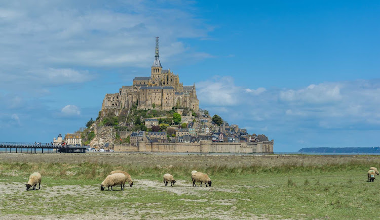 Explore the fortified island commune of Mont Saint Michel in Normandy, France.