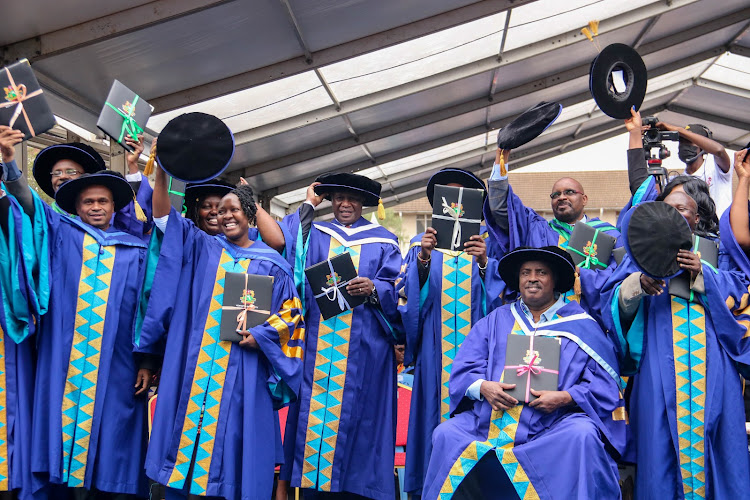 A group photo of the graduands who have graduated with PhD, at Kenyatta University on July 22, 2022, among the is Gen. Kibochi.