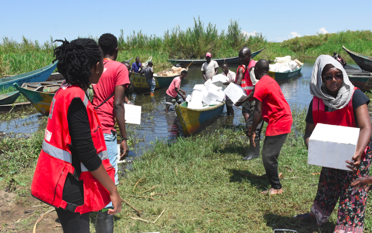 /home/kissfm/Downloads/Kenya Red Cross Volunteers offload non-food items from a boat at the shores of Lake Victoria, in Buluani Village, Busia County on May 15,2023.