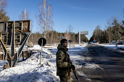 A member of the Ukrainian State Border Guard stands watch at the border crossing between Ukraine and Belarus on February 13, 2022 in Vilcha, Ukraine. 