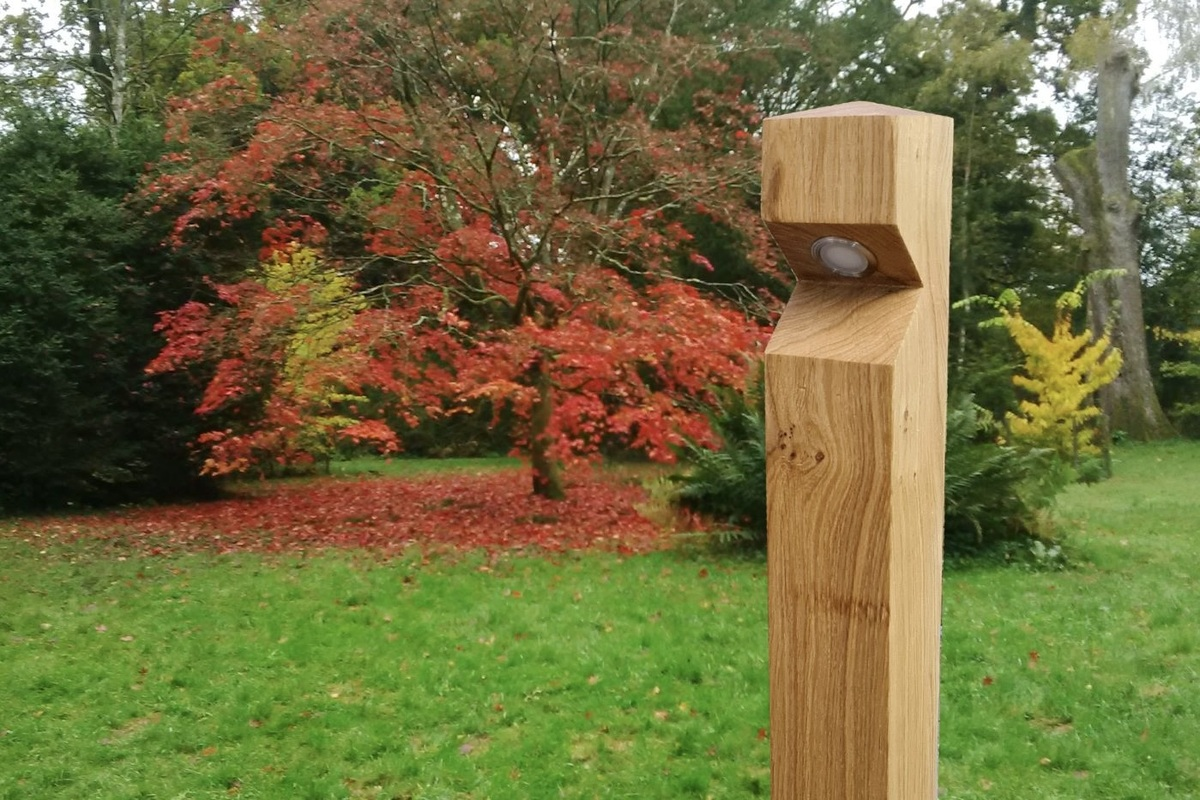 Wooden Barriers Direct bollard in a park, including energy-efficient LED lighting