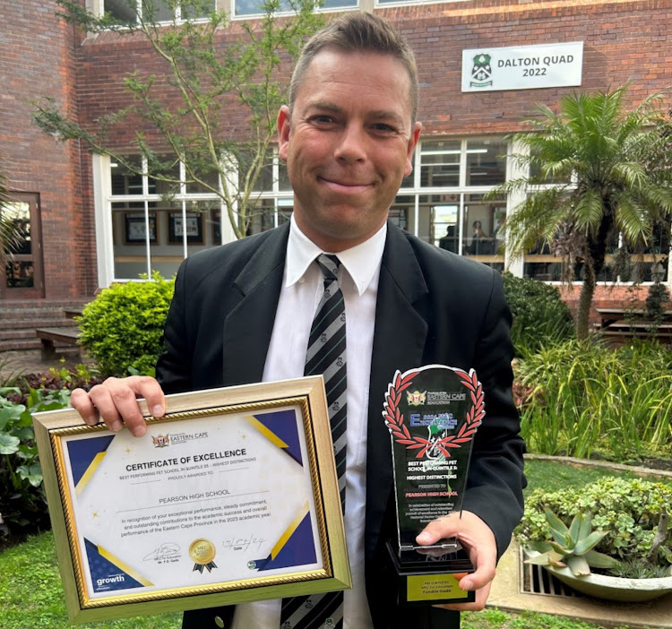Pearson High School principal Haldane Pienaar with awards the school achieved at the 2024 MEC Excellence Awards ceremony, held in East London.