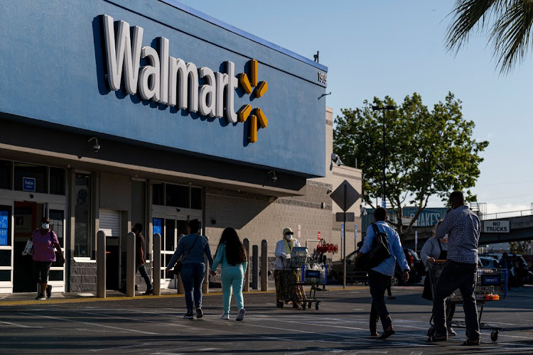 Shoppers walk in front of a Walmart store in San Leandro, California, US, on May 13 2021. Picture: BLOOMBERG/DAVID MORRIS