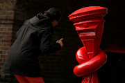 A woman looks at the sculpture ‘alphabetti spaghetti’ created by Alex Chinneck for the KCAW20 Public Art Trail in London. 