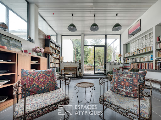 Living room with bookshelves and garden in this luxury house for sale in Villiers-sur-Orge ($927,404 - 390 m²)