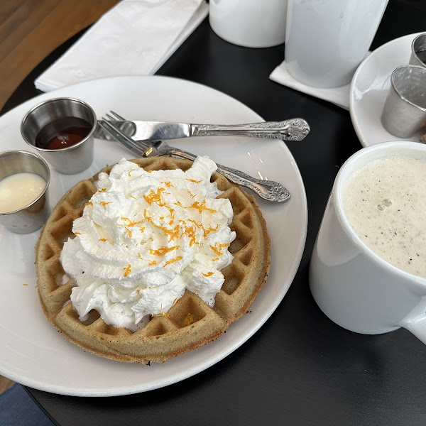 Seasonal cinnamon waffle with whipped cream and orange zest with an Earl Grey latte