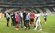 TS Galaxy team members confront match officials during the DStv Premiership match against Stellenbosch at Mbombela Stadium at the weekend.