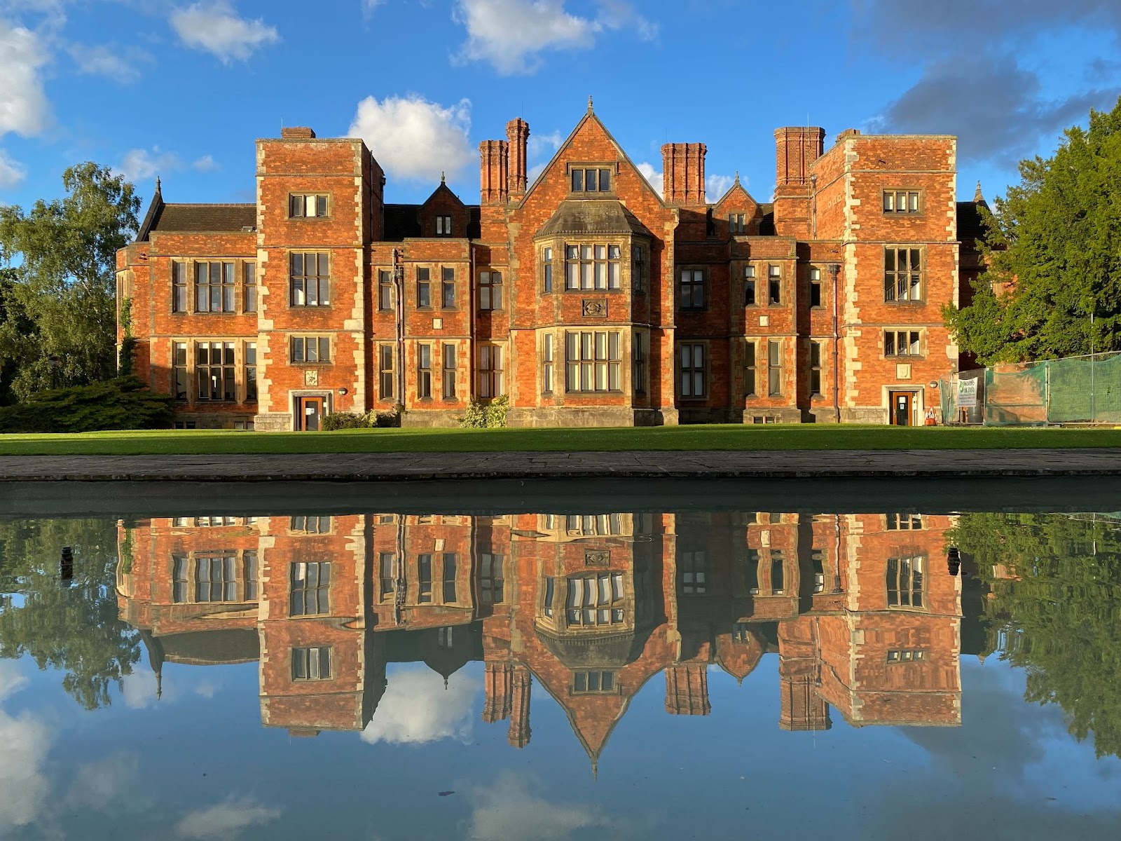 Heslington Hall with a pond in front of it at the University of York campus.