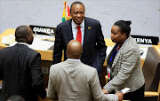 Kenya's President Uhuru Kenyatta (C) talks to Kenyan delegates during the Extraordinary Session of the Assembly of Heads of State and Government of the African Union on the case of African Relationship with International Criminal Court (ICC), in Ethiopia's capital Addis Ababa. Reuters