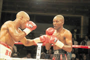 SHOCK: Thompson Mokwana, left, punishes Patrick Malinga on his way to victory by TKO in the seventh  round for the SA lightweight title. PHOTO:  Bafana  Mahlangu