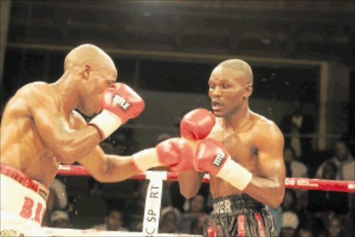 SHOCK: Thompson Mokwana, left, punishes Patrick Malinga on his way to victory by TKO in the seventh round for the SA lightweight title. PHOTO: Bafana Mahlangu