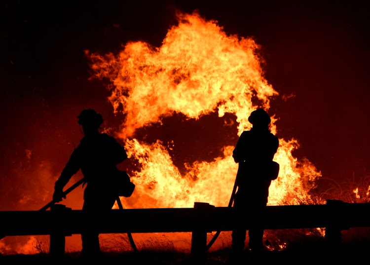 Firefighters in Canyon Country, north of Los Angeles, California, US, in October 2019. Picture: REUTERS/GENE BLEVINS