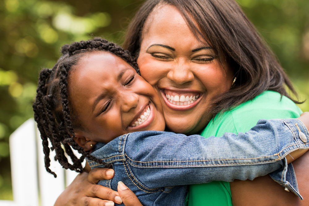 Mother and daughter hugging and smiling