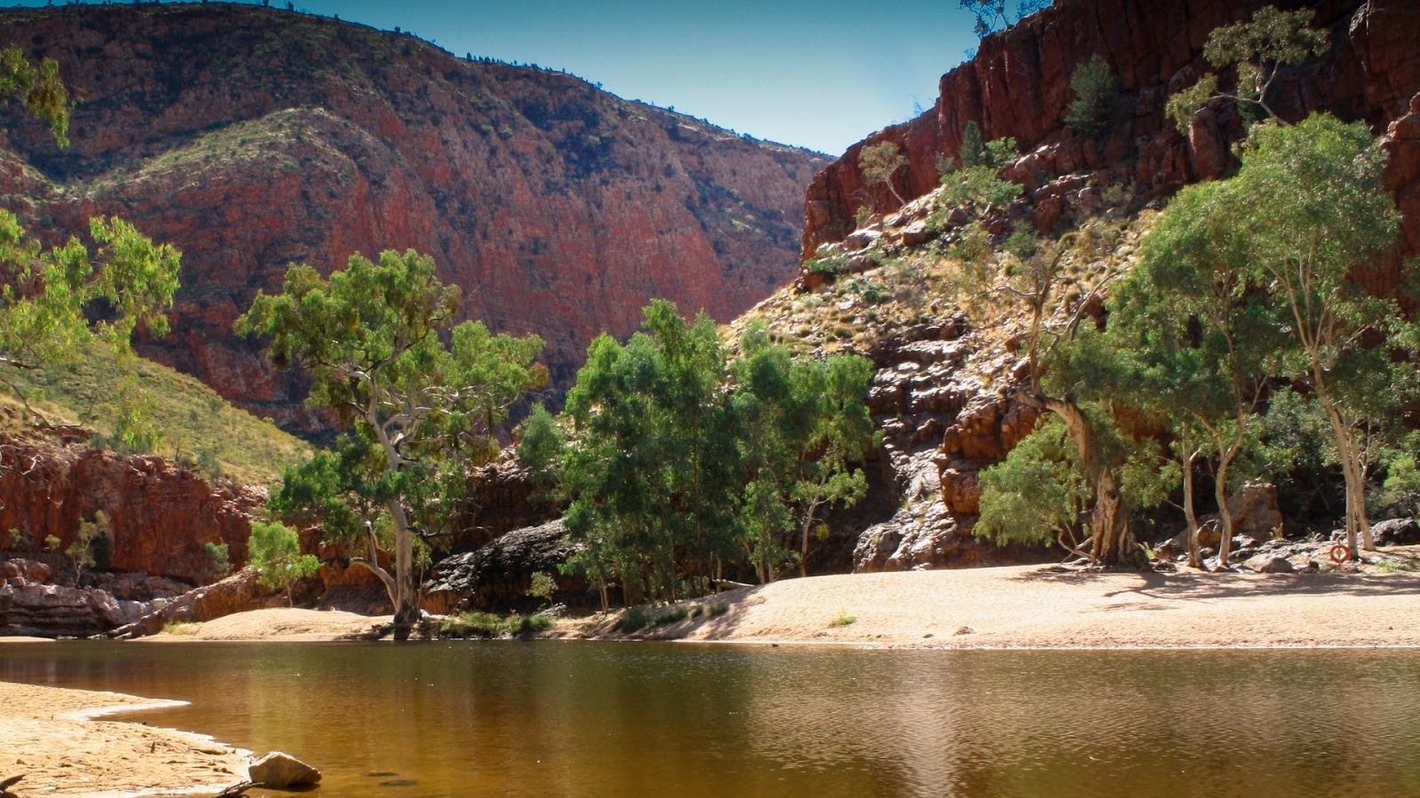 A river gorge flanked by red rocks