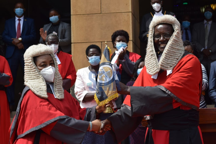 David Maraga hands over the Judiciary instruments of power to acting Chief Justice Philomena Mwilu at the Supreme Court on January 11, 2021.