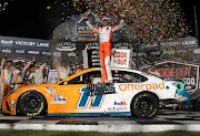 Denny Hamlin celebrates after winning the NASCAR Cup Series Cook Out Southern 500 at Darlington Raceway on September 5 2021 in South Carolina.