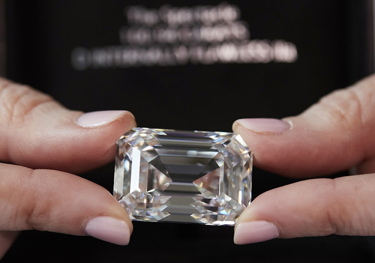 A staff holds a D colour, internally flawless rectangular step-cut diamond of 100.94 carats during a preview at Christie's before its auction sale in Geneva, Switzerland, May 7, 2021.