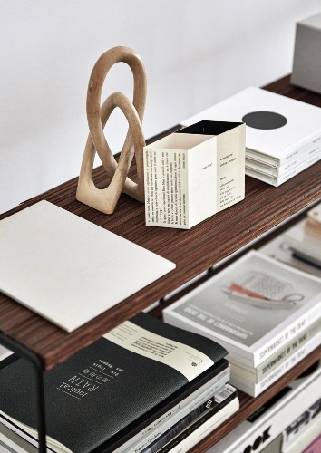 The vintage Scandi shelves in the living room used for books, catalogues and magazines.