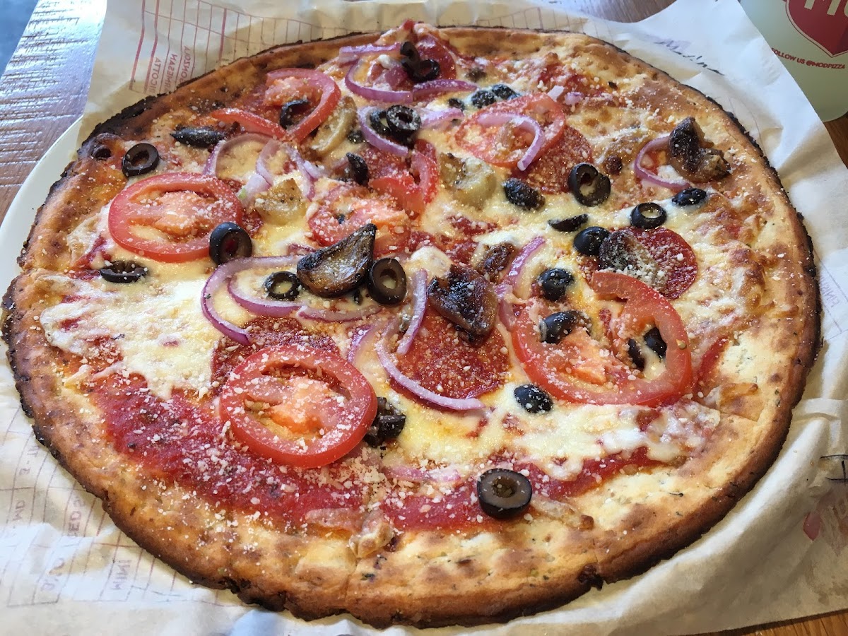 GF Cauliflower Crust Pizza with red sauce, mozzarella, pepperoni, onions, olives and fresh tomatoes.