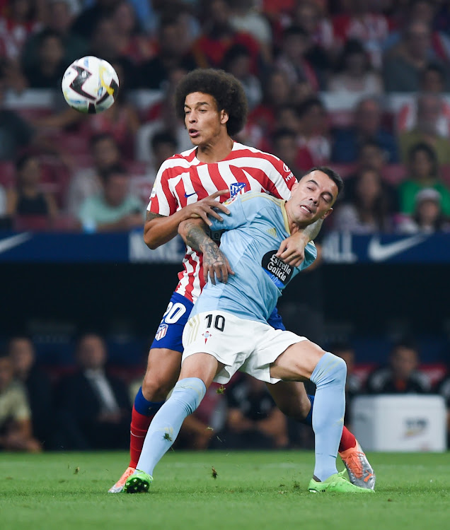 Celta Vigo's Iago Aspas (10) vies for the ball with Atletico Madrid's Axel Witsel on September 10, 2022