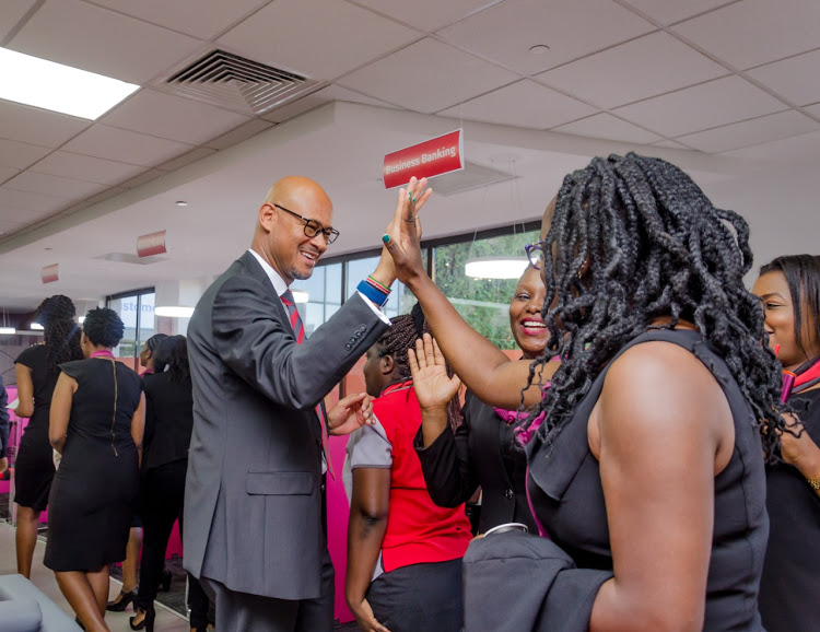 Absa Bank Kenya PLC managing director Jeremy Awori celebrates with staff at the Sarit Centre branch during the official unveiling of the Absa brand in Kenya on February 10, 2020/