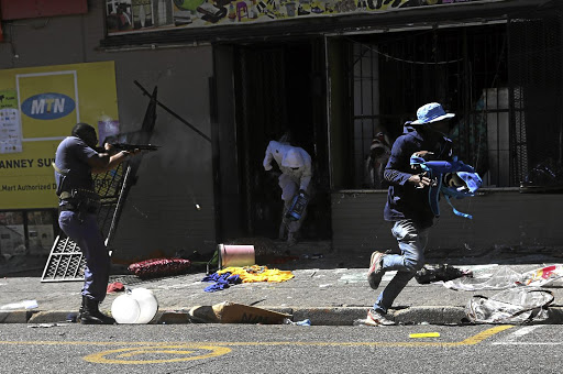 Human Rights Watch says SA's five-year national action plan to combat xenophobia and other crimes, while an important step, fails to address the lack of accountability for xenophobic crimes and has no clear implementation strategy. In this 2019 photograph, police take on looters in Katlehong during a wave of attacks on foreign-owned shops.