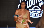 Mara Martin breastfeeds her daughter while walking the ramp at the Sports Illustrated swimsuit show in Miami.