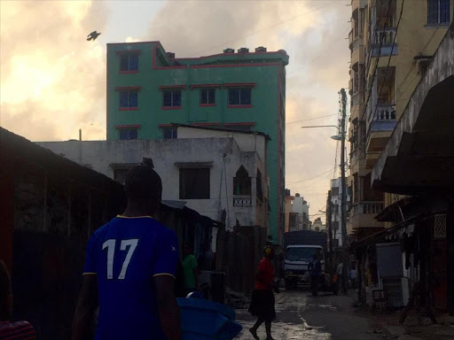 Residents of Majengo stroll on the streets near a building where a woman was arrested on Monday September 19 over links to Mombasa police station attack. /ELKANA JACOB