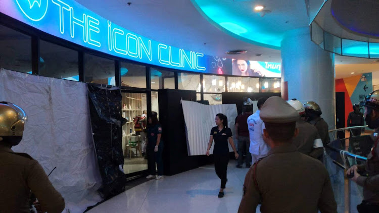 Emergency services are seen in front of a cosmetic clinic after a shooting at a shopping mall in Bangkok, Thailand February 18, 2020.