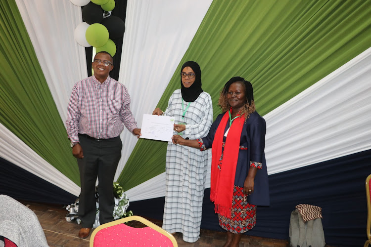 Gubernatorial hopeful Faustine Mghendi and his running mate Immah Nduku receive a certificate from IEBC county manager Eisha Mohamed on June 4, 2022.