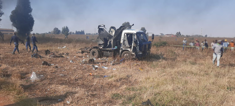 The veld was littered with debris after the cash van was blown apart.