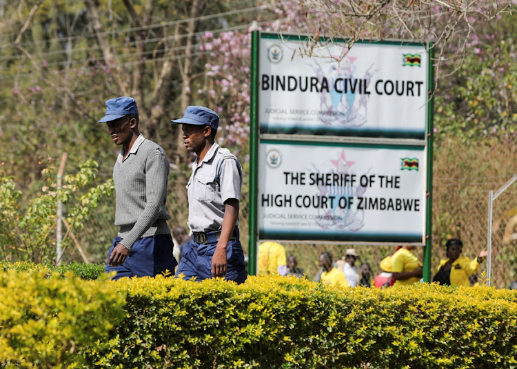 Zimbabwe's police walk during a court hearing of main opposition party Citizen Coalition For Change (CCC) outside Bindura Civil Court in Bindura, Mashonaland Central Province, Zimbabwe, July 9, 2023. REUTERS/Philimon Bulawayo